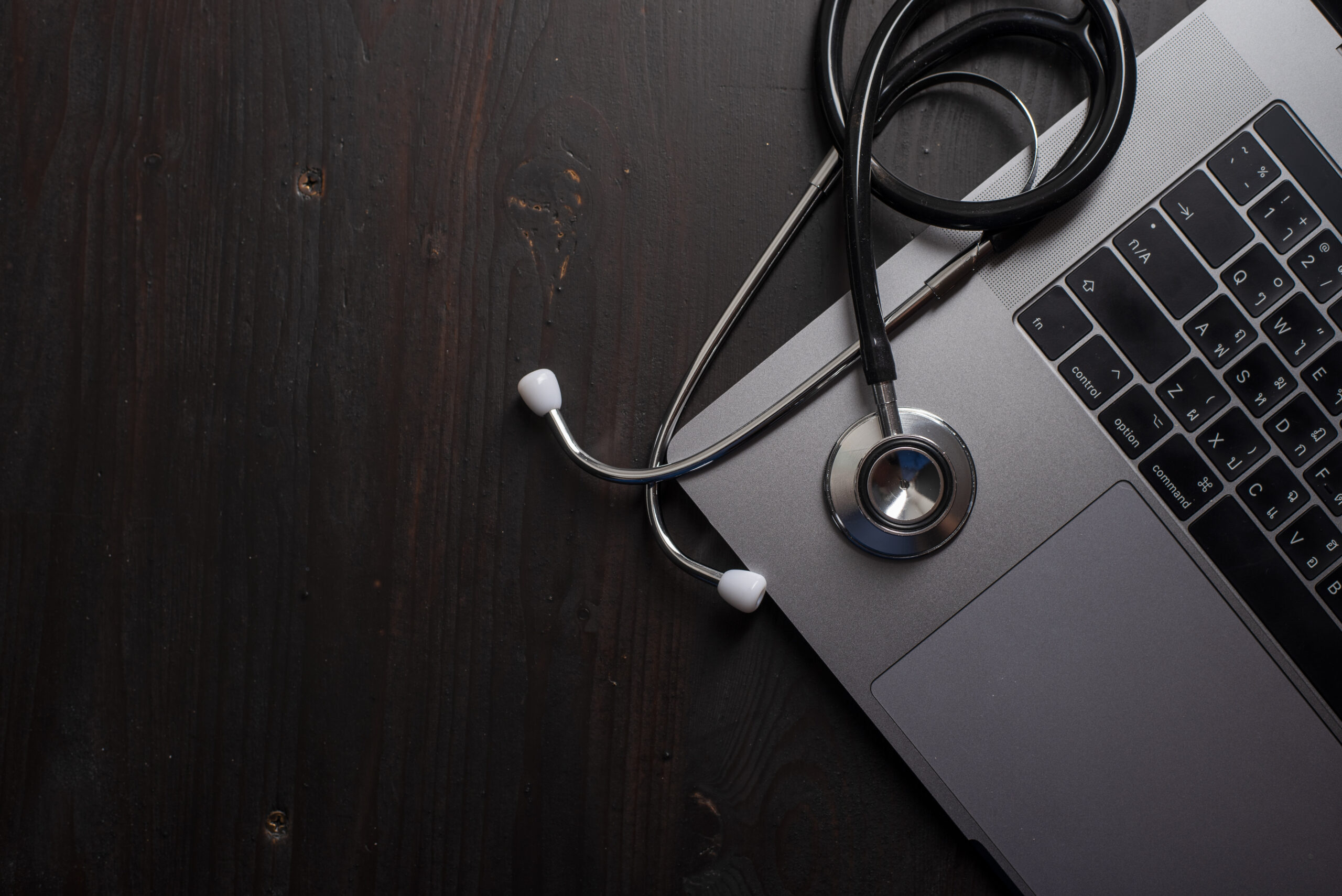 Medical stethoscope beside a laptop for healthcare technology