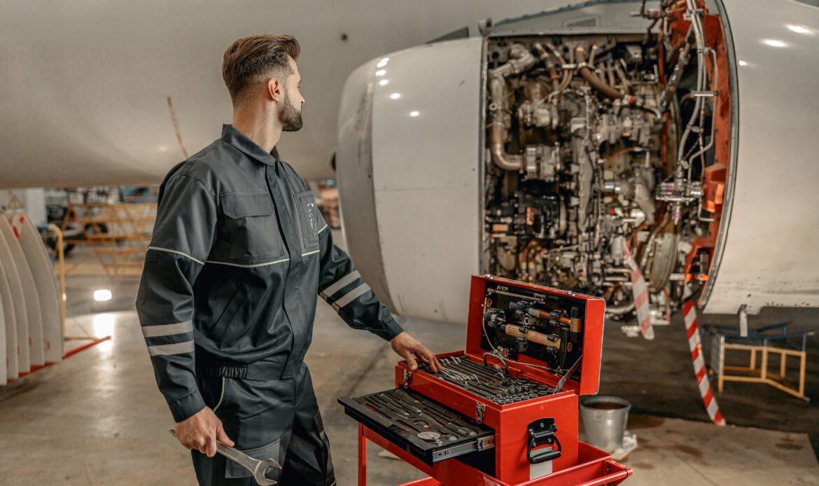 male aircraft mechanic using tool box hangar scaled