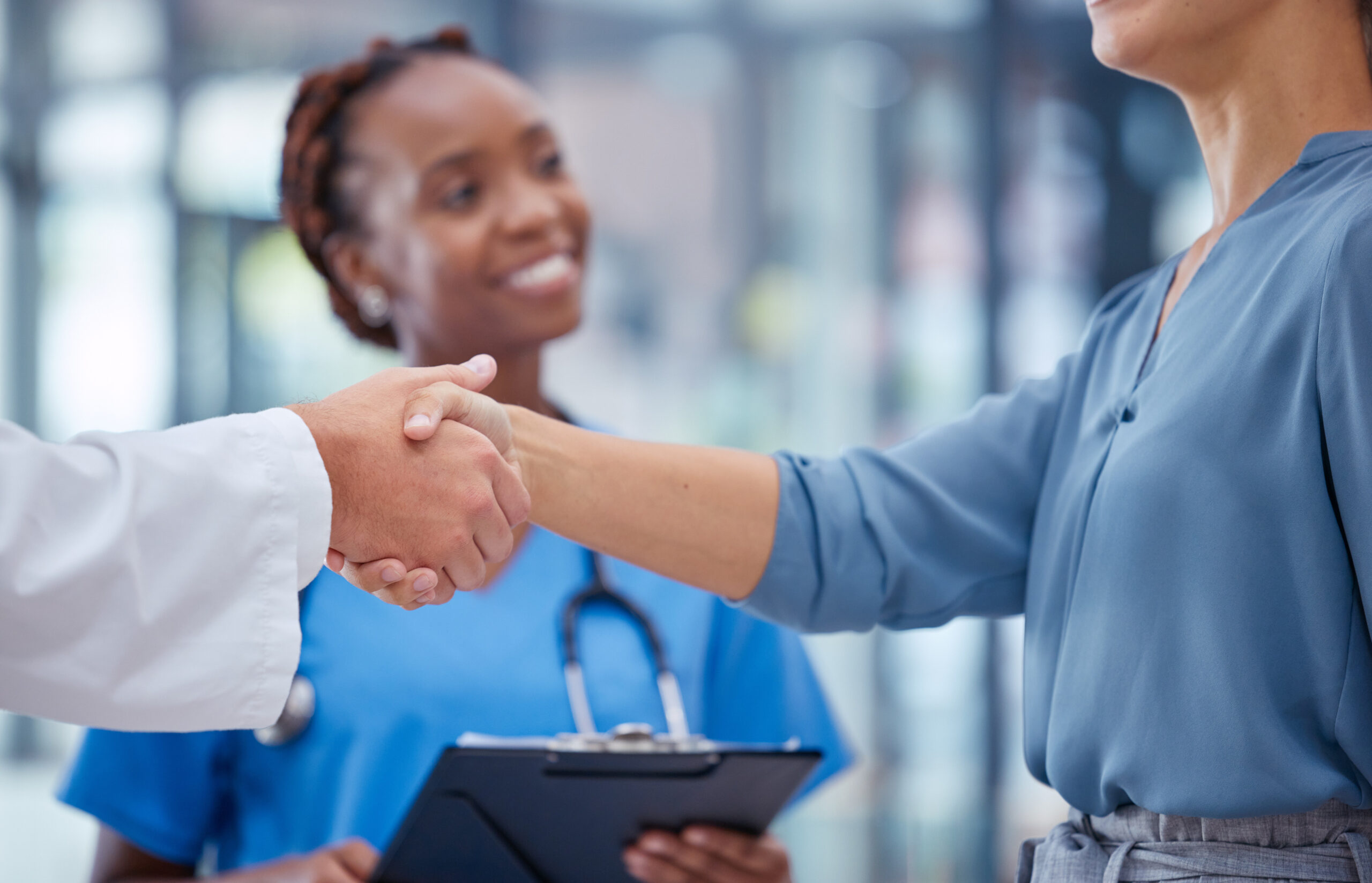 doctors handshake thank you greeting good medical breakthrough success with smiling nurse background physician healthcare worker patient shaking hands innovation health research