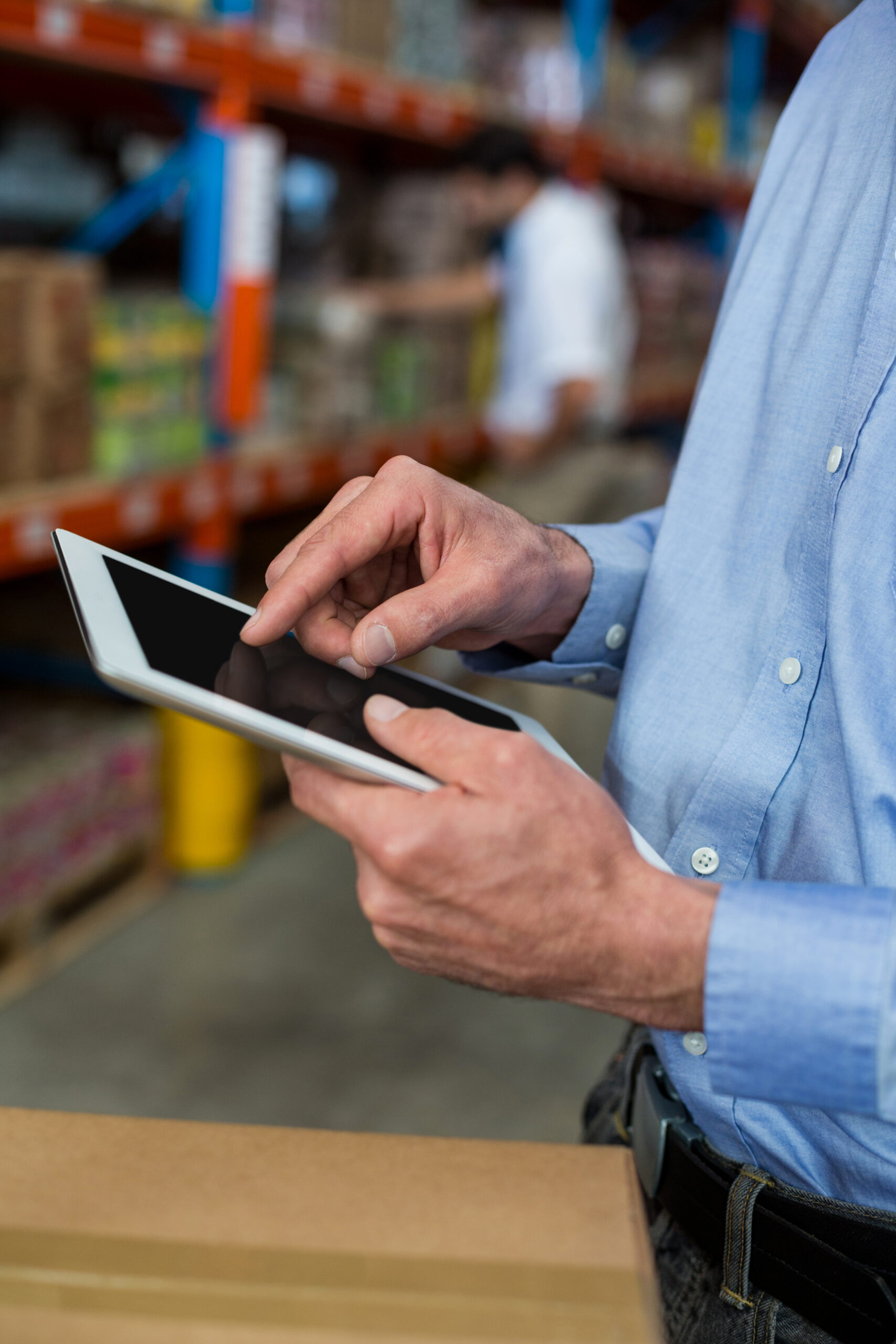 Warehouse professional using a tablet for inventory tracking