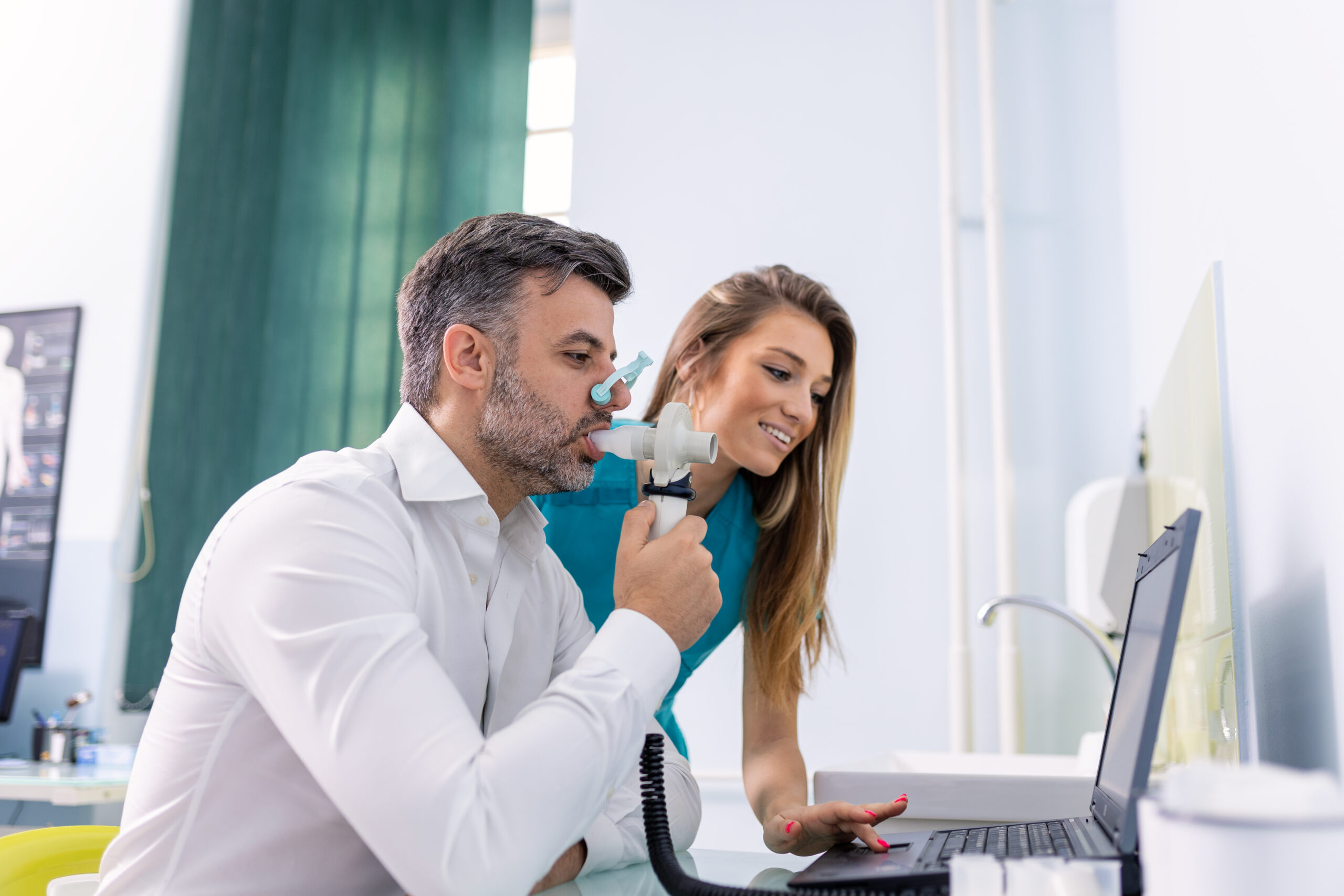 Adult man testing breathing function by spirometry having health problem. Diagnosis of respiratory function in pulmonary disease.