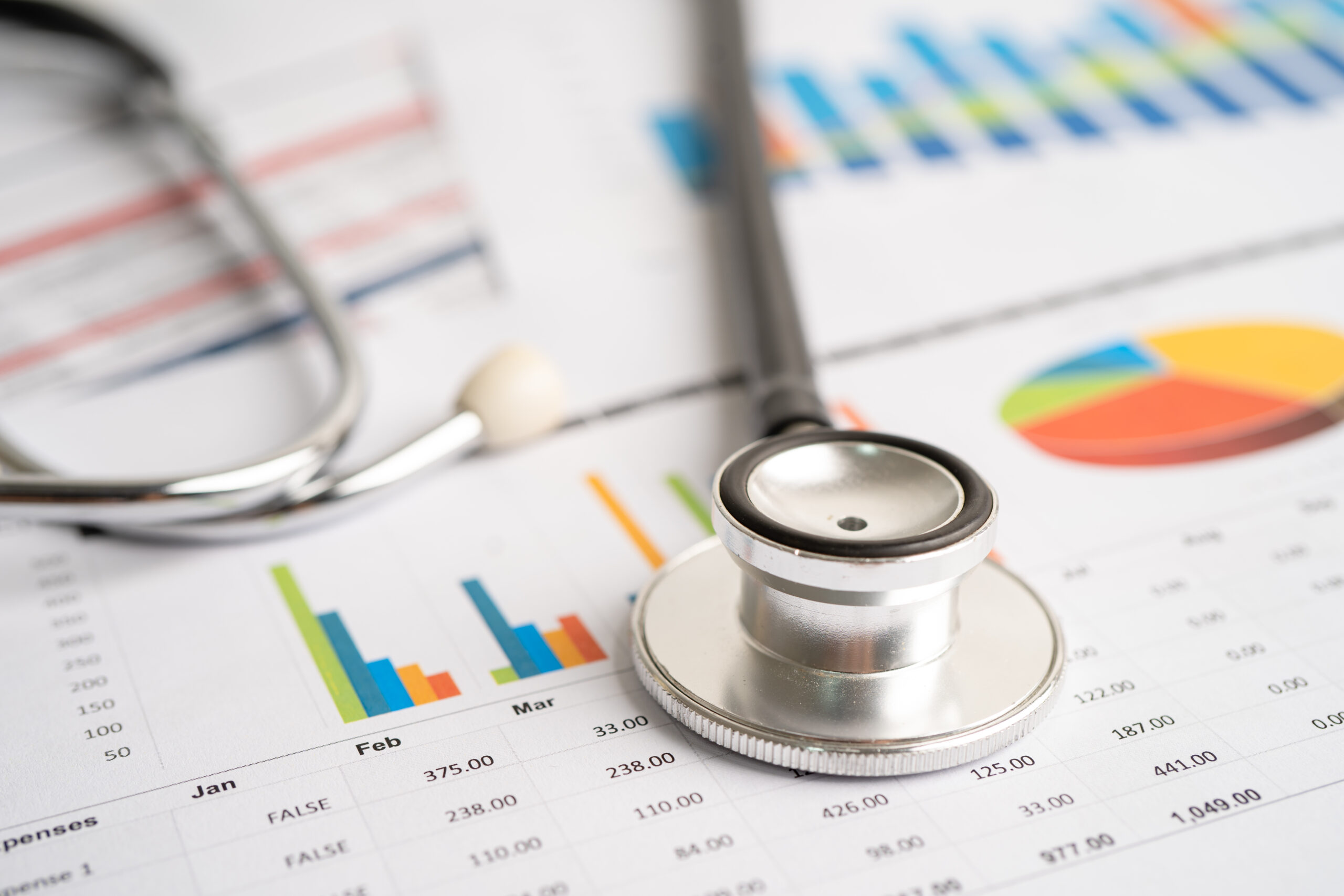 stethoscope on chart and graph paper finance account statisti