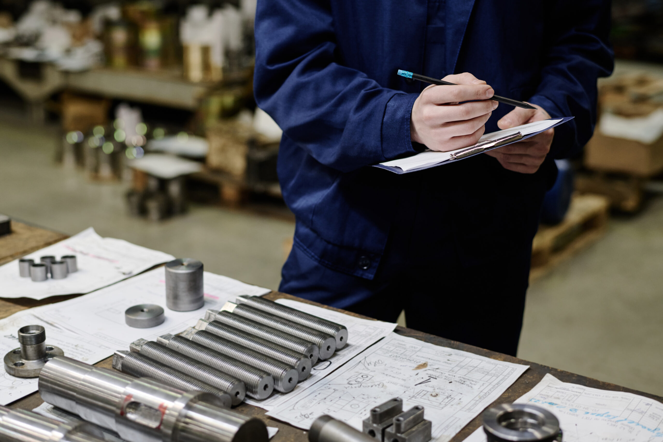 Specialist inspecting precision metal parts