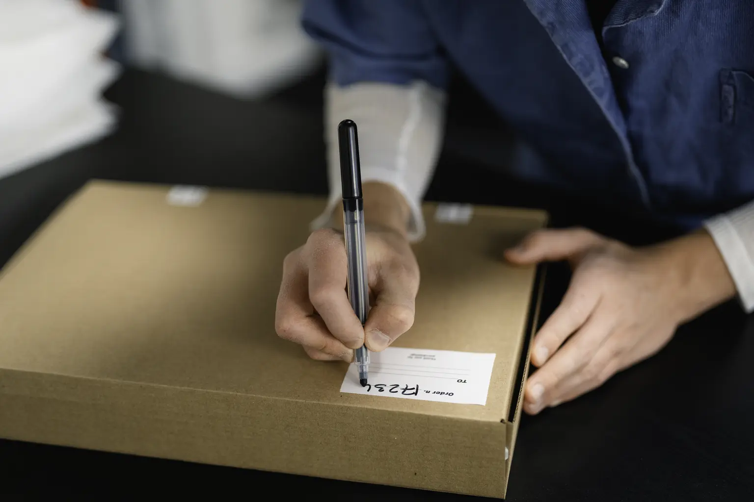 Operations professional preparing a shipment and tracking information